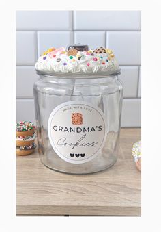 a glass jar filled with frosting and sprinkles