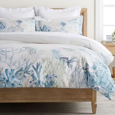 a bed with blue and white comforters in a bedroom