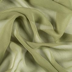 Mood's Premium Pesto Silk Crinkled Chiffon is a sheer, lightweight and ethereal fabric with a subtle, crinkled texture. An excellent choice for fluid, top-weight garments, overlays, flowing scarves, and sheer insets such as ruffle details and draped extensions. 

Note: Dye lots are subject to change up to 10% in either direction. Ordering swatches is HIGHLY recommended for these products. Luxury Sheer Chiffon Dress For Wedding, Luxury Elegant Summer Tulle Fabric, Stretch Chiffon Fabric, Tan Chiffon Fabric, Cotton Silk Clothing Fabric, Luxury Green Chinon Sets, Chiffon Swatch Fabric, Luxury Silk Chiffon Dress, Luxury Flowy Silk Chiffon Dress