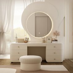 a white vanity with a round mirror and stool in front of it, next to a large window