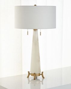 a white lamp sitting on top of a table