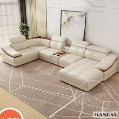 a living room with a large sectional couch and coffee table on the rug in front of it