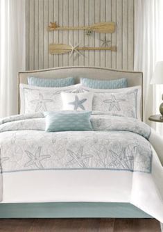 a white and blue bed in a bedroom