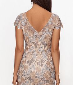 the back of a woman's dress with flowers on it and an open v - neckline