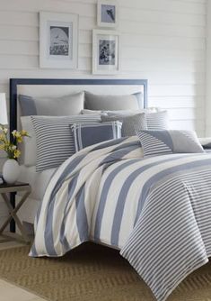 a bed with blue and white striped comforter