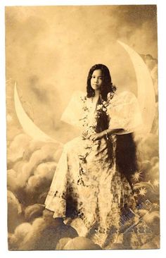 an old fashioned photo of a woman sitting on the moon with flowers in her hand