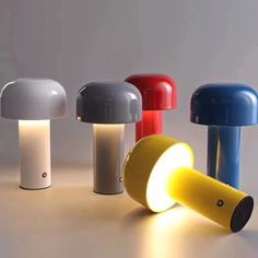 three different colored lamps sitting next to each other