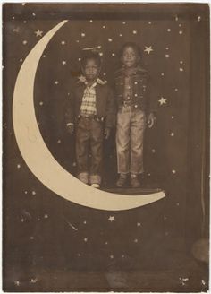 an old photo of two children standing on the moon