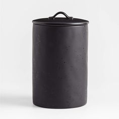 a black canister sitting on top of a white table