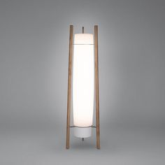 the floor lamp is made out of wood and has a white glass shade on it