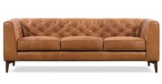 a brown leather couch sitting on top of a white floor