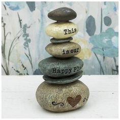 a stack of rocks with the words,'this is our happy place'written on them