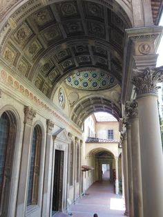 the inside of an old building with columns and arches