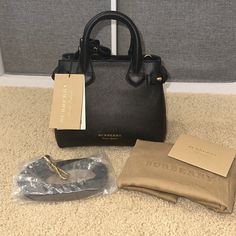 Burberry Baby Banner Black Leather Handbag Brand New, Tags Attached, Dust Bag Included, Care Cards Included, Shoulder Strap Included Designer: Burberry Article Number: 8036492 Style: Tote/Shoulder Bag Condition: New With Tags And Dust Bag Measurements: 10.5” Long, 8” High, 4.5” Deep Size: Small/ “Baby Banner” Material: Leather Color: Black Hardware Color: Polished Gold-Tone Msrp Us $1150 Banner Material, Burberry Baby, Black Leather Handbag, Baby Banners, Bag Measurements, Black Handbag, Small Baby, Black Leather Handbags, Branded Handbags