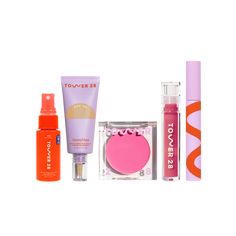 an assortment of cosmetics and makeup products on a white background, including lipstick, eye shadow, lip balm, face powder, sunscreen