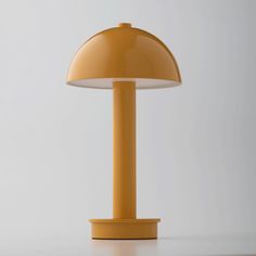 a yellow table lamp sitting on top of a white counter