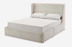 an upholstered bed frame with two pillows on top and bottom, viewed from the side