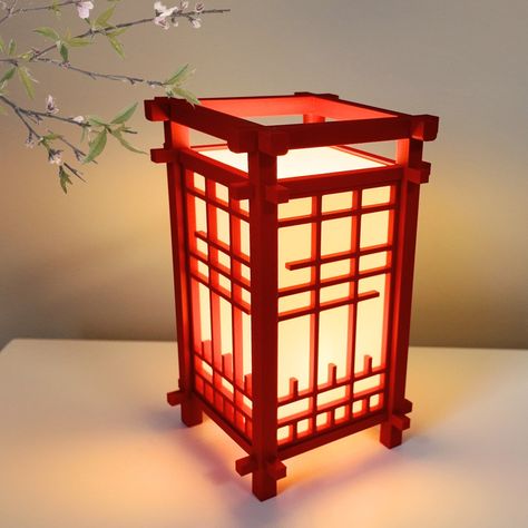 Product Name:  3D-Printed Japanese Lantern Shoji Style Desk Lamp Product Description: Envelop your workspace in a serene ambiance with our meticulously crafted 3D Printed Japanese Lantern Desk Lamp in Shoji Style. Inspired by the elegance of traditional Japanese shoji screens, this exquisitely designed lamp seamlessly blends cultural heritage with modern functionality, providing both illumination and an artistic essence to your desk or table. Included: -3D Printed Japanese Lantern Shoji Style Desk Lamp -E12 Base, E12 LED Light Bulb Included (3000K Soft Warm White) -US Cord with Rotary On/Off Switch Product Dimensions: Width: 4.05 inches Height: 6.75 inches Available Colors: Crimson Red Midnight Navy Olive Green Jet Black Ivory White Ash Grey Product Material: 3D Printed in PLA (Polylactic Red Japanese Lanterns, Chinese Decorations Ideas, Japanese Theme Bedroom, Traditional Japanese Decor, Japanese Lamps Traditional, Japanese Inspired Room, Japan Room Decor, Japanese Home Decor Traditional, Japanese Paper Lamp