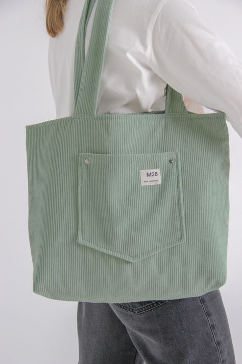 This bag handmade with love in SaintPetersburg!Basic design is perfect choice for everyday&casual outfits. There is one pocket outside the bag for small items as keys, cards, smartphone and so on.Size: 36x45 cm, handles 70 cmMaterial of top: corduroy polyesterColour: mint Desain Tote Bag, Canvas Bag Design, Handmade Fabric Bags, Tote Bag With Pockets, Everyday Casual Outfits, Everyday Tote Bag, Diy Bag Designs, Tote Outfit, Tote Bags Sewing