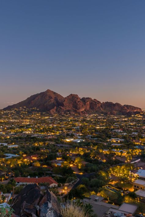 Camelback Mountain lit up with Scottsdale city lights for a magnificent view only available at this 2-acre lot in Paradise Valley, Arizona. City With Mountains, Arizona City At Night, Paradise Valley Arizona Houses, Phoenix City Aesthetic, Houses In Arizona, City View From Mountain, Arizona Mansion, Camelback Mountain Arizona, Arizona Wallpaper