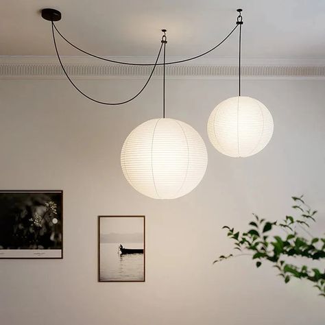 Illuminate your space with the timeless elegance of the Akari 55A Style Pendant Light. Inspired by traditional Japanese design, this pendant light features a delicate, spherical lantern made from handmade rice paper. Its soft, warm glow creates a serene and inviting atmosphere, perfect for any room in your home. Whether you're enhancing your dining area, brightening up your living room, or adding a touch of sophistication to your workspace, the Akari 55A effortlessly blends functionality with ae Paper Lantern Living Room, Parisian Terrace, Rice Paper Shade, Hanging Paper Lanterns, Paper Balloon, Romantic Ambiance, Hotel Lobbies, Shoji Screen, Lantern Pendant Lighting