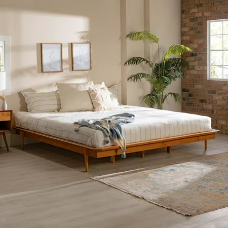 Accentuate your natural style with the Manor Park Mid Century Modern Wood Platform King Bed. This frame provides a perfect mix of style and function with attractive tapered legs and wood support slats. The solid wood build offers a long-lasting piece to enjoy in your bedroom or guest room. Place it in a retro, modern, or boho-style home for an elevated look. You can feel good about this purchase, as the wood is harvested responsibly from renewable forests. Pair with your favorite king headboard Philly Apartment, Platform King Bed, Mcm Bedroom, Boho Bedrooms, Mid Century Modern Bed, Wood Platform Bed Frame, Modern Bed Frame, Bed With Headboard, Bed Platform