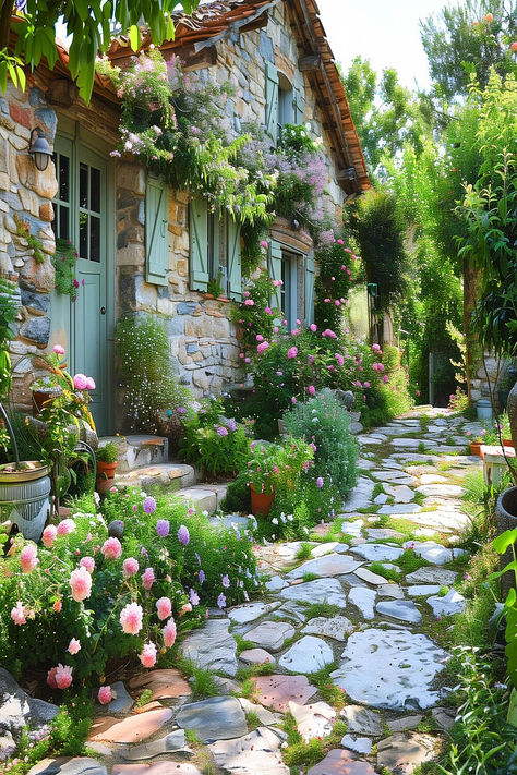 Lush garden with blooming hydrangeas and a charming stone cottage. Cottage Garden Walkway, French Stone Cottage, Mediterranean Cottage Garden, Front Cottage Garden, French Country Gardens, French Garden Ideas, Cottage Garden Inspiration, Cottage Outdoor Decor, Garden Inspiration Ideas