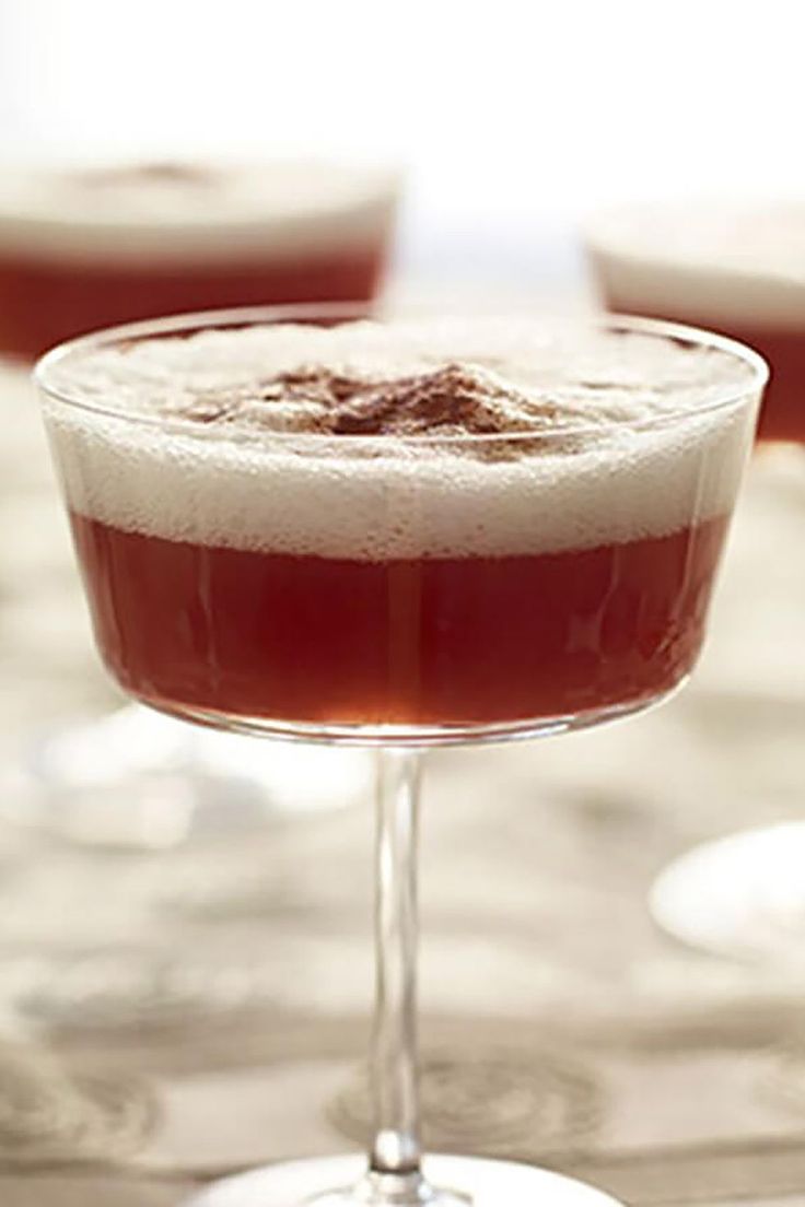 two glasses filled with liquid sitting on top of a table