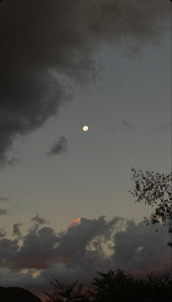 the sun is setting behind some dark clouds