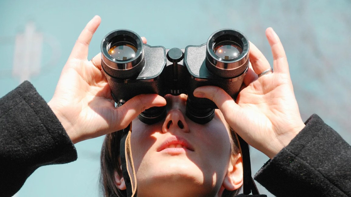 woman uses binoculars 