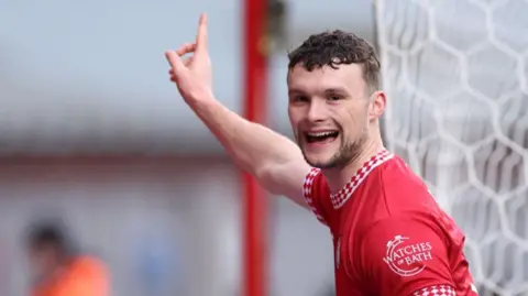 Luke McNally celebrates his winner for Bristol City against Derby