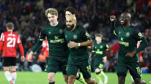 Brentford players Mads Roerslev, Bryan Mbeumo and Yoane Wissa celebrate victory over Southampton