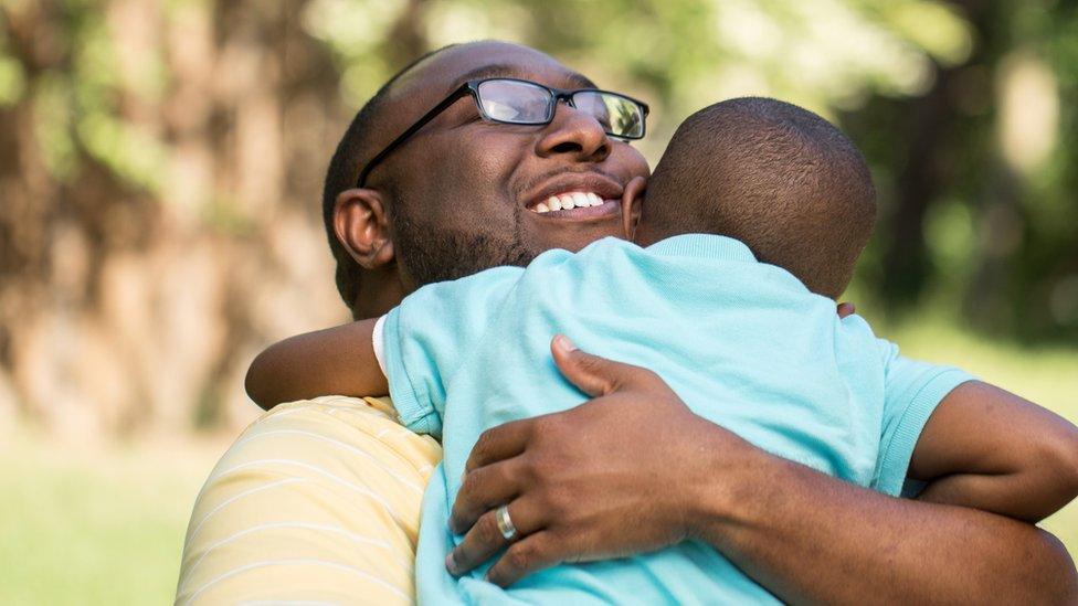 Father hugging son