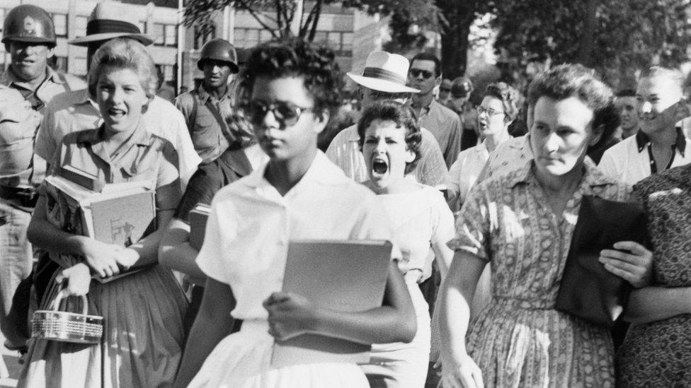 Elizabeth Eckford ignores the hostile screams and stares of fellow students on her first day of school. She was one of the nine students whose integration into Little Rock's Central High School