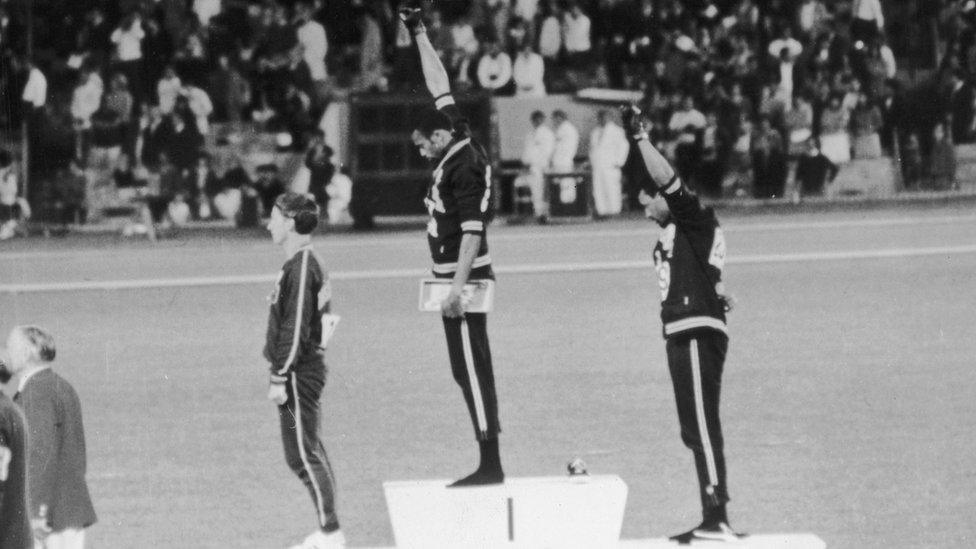 American track and field athletes Tommie Smith and John Carlos, first and third place winners in the 200 meter race, protest with the Black Power salute as they stand on the winners podium at the Summer Olympic games, Mexico City, Mexico.