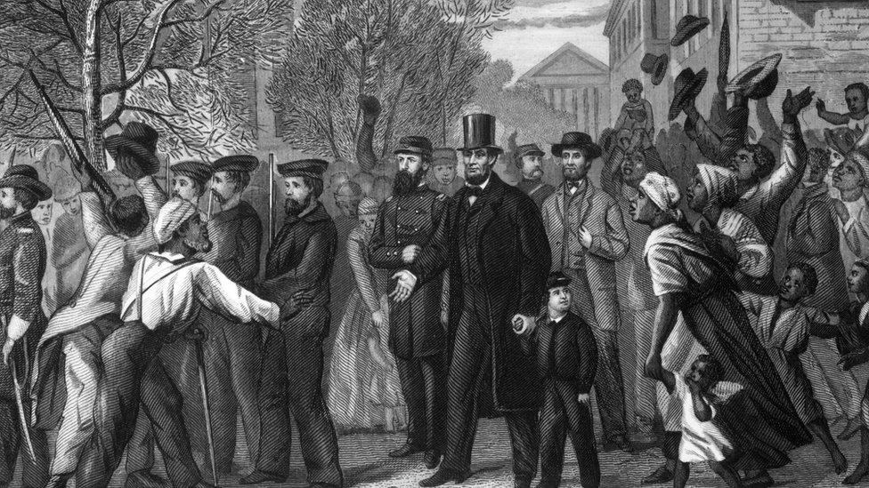 3rd April 1865: Abraham Lincoln in Richmond, Virginia, shortly after it was captured by Union troops who freed the slaves that are crowding around the President. Engraving by J C Butt after a drawing by L Hollis