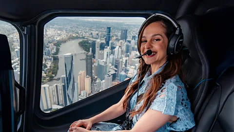 Melanie Zanetti in a helicopter overlooking the city of Brisbane, Australia (Credit: Nic Morely)