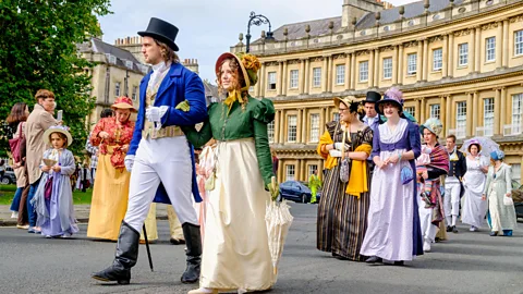 People walking in Regency-era costumes (Credit: Alamy)