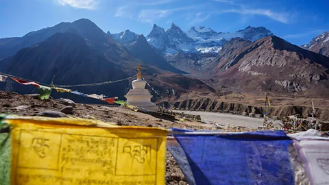 Flags and a structure on a mountain in the Himalayas (Credit: Matt Stirn)