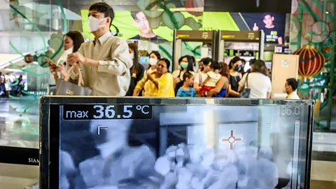 People walking past a heat scanner in a Thai shopping mall in January 2020 (Credit: Mladen Antonov/ AFP/ Getty Images)