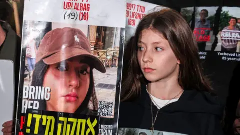 poster of israeli hostage Liri Albag with a female relative next to it