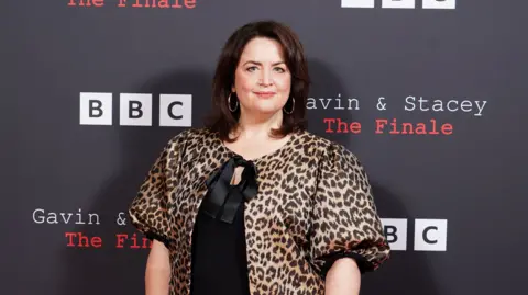 Ruth Jones wearing a black dress and leopard print top at a red carpet event for the Gavin & stacey finale.