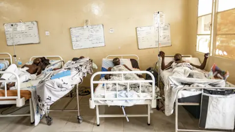 Wounded men in hospital beds