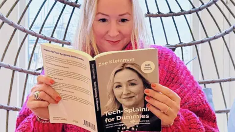 BBC technology editor Zoe Kleinman holding the AI-made book that one of her friends brought her as a present