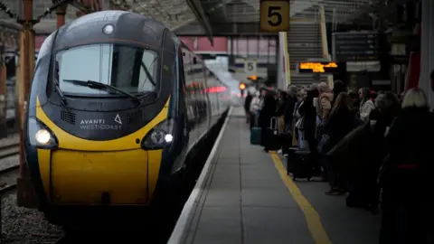 Getty Images Avanti West Coast train with passengers waiting on a platform number 5