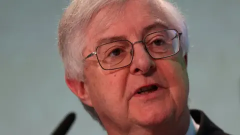 Mark Drakeford, who has grey hair and glasses