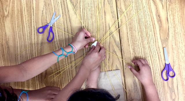 Students build a structure out of pasta