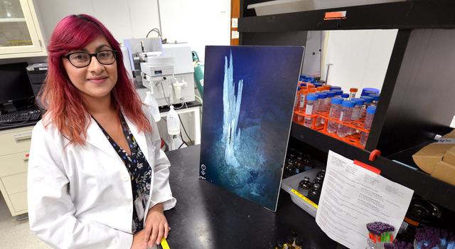 Erika Flores poses for a photo in the lab at JPL