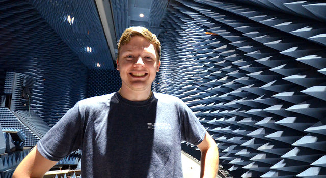 JPL intern Zachary Luppen stands in an anechoic chamber