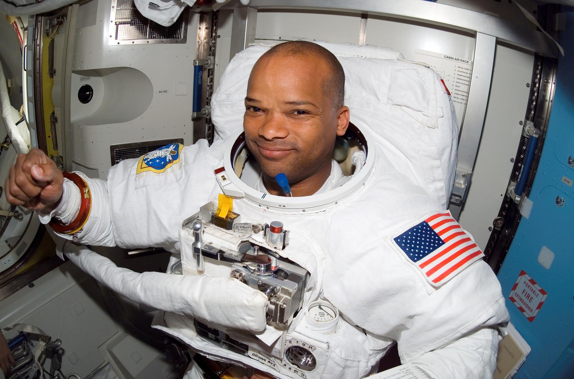 Robert Curbeam smiles in his spacesuit after completing the first spacewalk for the STS-116 mission.